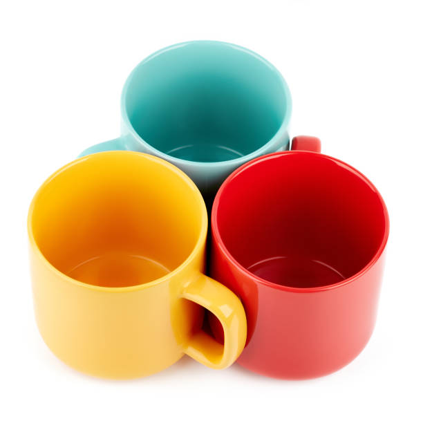 istock Colored cups for coffee and tea on a white background. Place for your text. 1564751588