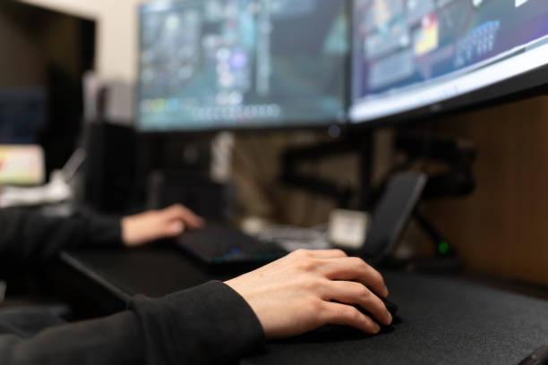 istock Asian male playing computer video games online. 1564768946