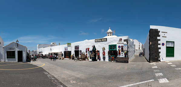 Teguise, Lanzarote, Canary Islands, Spain - April 23, 2023: Tourists shopping in the cute shops of Teguise, a touristic town on the island of Lanzarote.