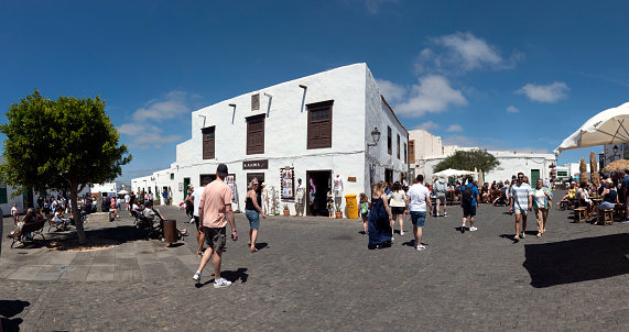 Teguise, Lanzarote, Canary Islands, Spain - April 23, 2023: Tourists shopping in the cute shops of Teguise, a touristic town on the island of Lanzarote.