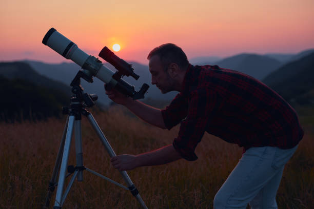 istock Astronomer looking at the skies with a telescope. 1564794327