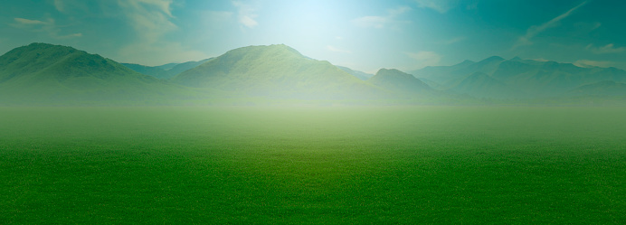 Landscape view of green grass on slope with blue sky and clouds background, cloud mountain tropic valley landscape, wide misty panorama