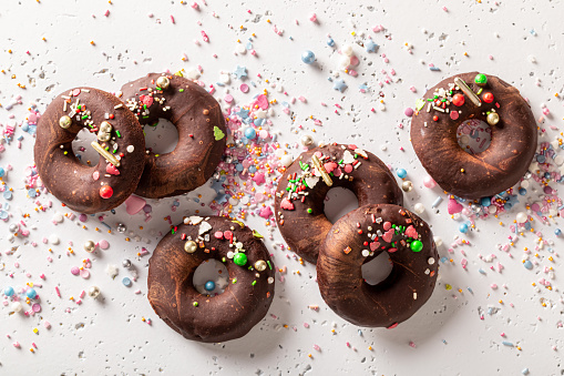 Dark brownie donuts made of sprinkles and chocolate. Unique donuts made of brownie and chocolate.