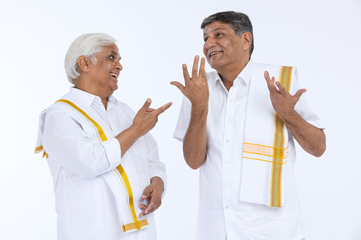 South indian  senior men embracing each other isolated on white background.