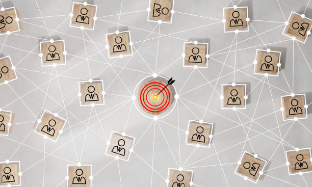 istock Red dartboard and black arrow connection linkage with human icon for customer focus target group and customer relation management concept. 1564811360