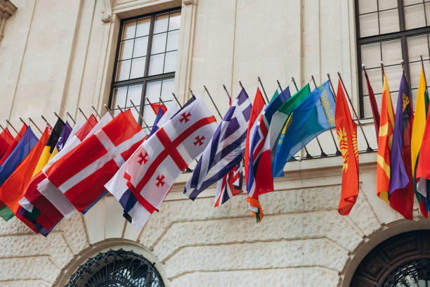 istock National flags of various countries flying in the wind. Colorful flags from different countries 1564811897