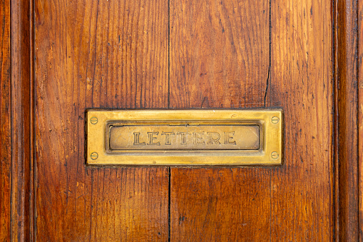 Letterbox on a brown door background. Close-up View of a Beautiful old Letter Box