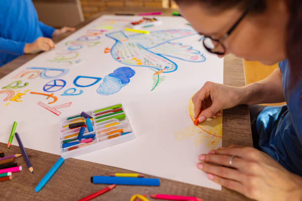 Together for Peace A mother's guidance helps her daughter bring her artistic vision for peace to life. pigeon family stock pictures, royalty-free photos & images