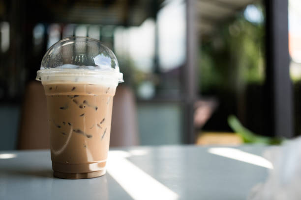 Refreshing iced Mocha coffee on table in a garden cafe on a beautiful summer day.