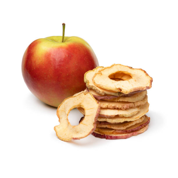 istock Heap of dried apple chips and a fresh Elstar apple on white background 1564850489