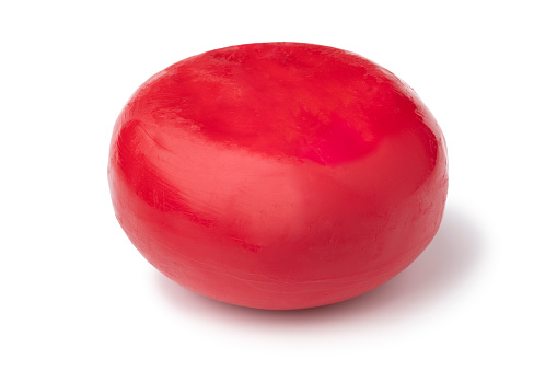 Traditional Austrian red waxed Ratsherrenkase isolated on white background close up