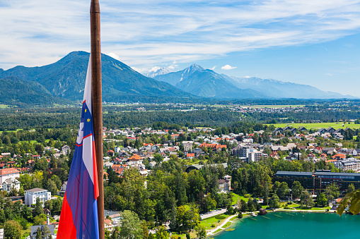 Bled is a beautiful town in Slovenia known for its stunning lake, Bled Lake, and an island with a church in the middle. The lake is surrounded by lush greenery and a castle on a cliff.