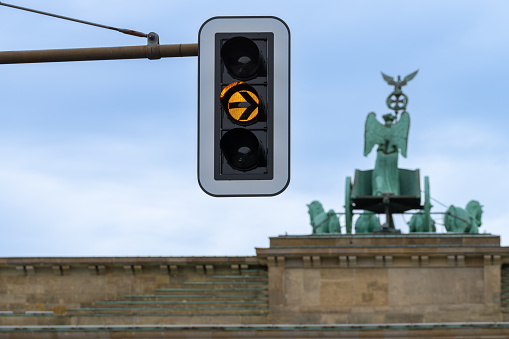 Low angle view of traffic light against Quadriga Statue at Brandenburg Gate