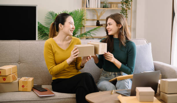 istock Starting small businesses SME owners, two check online orders Selling products working with boxs freelance work at home office using tablet and laptop marketing concept 1564863076