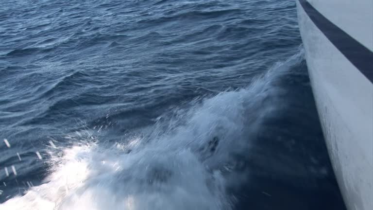 Foam, waves and water on camera during movement of yacht