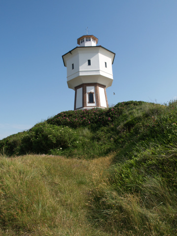 Lighthouse of Texel sticking out of the dunes.
