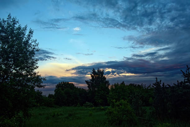 Bright colorful sunset in the village, in summer