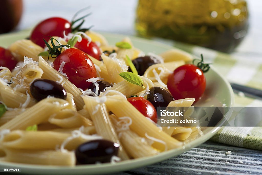 Pasta with fresh tomatoes and olives Penne pasta with a tomato , parmesan, olives and fresh basil. Basil Stock Photo