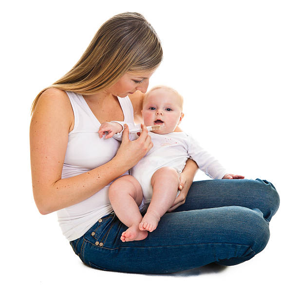 istock Mother giving vitamins to infant 156494728