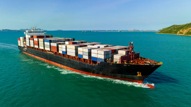 istock cargo container ship sailing in sea to import export goods and distributing products to dealer and consumers across worldwide, by container ship Transport business,  drone shot 1564948130