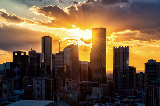 The silhouette of the modern skyline of Houston, Texas as the sun sets beyond on an early spring evening shot from an altitude of about 600 feet during a helicopter photo flight.