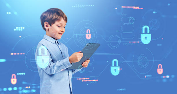 istock Smiling child with tablet in hands, portrait with cybersecurity 1564984161