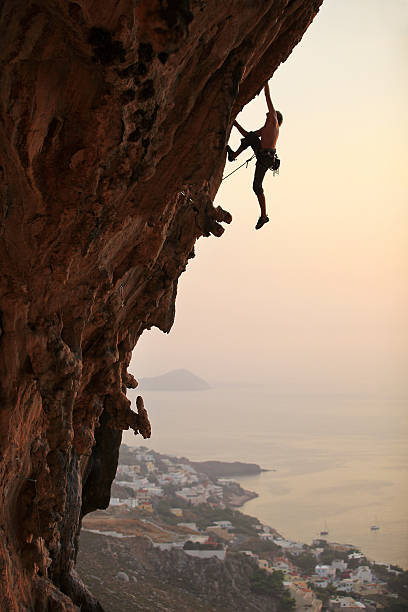 Rock climber at sunset stock photo