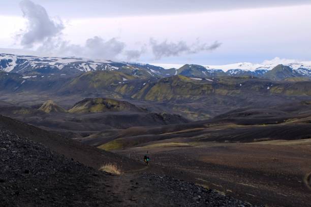 istock Rugged mountain path, surrounded by picturesque snow-capped peaks: Laugavegur trail, Iceland 1565011273