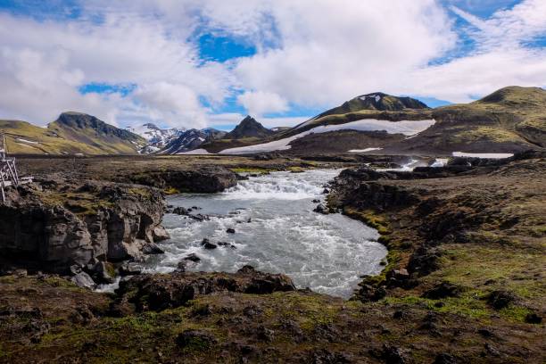 istock the water has been flowing under some rocks and snow mountains 1565011292