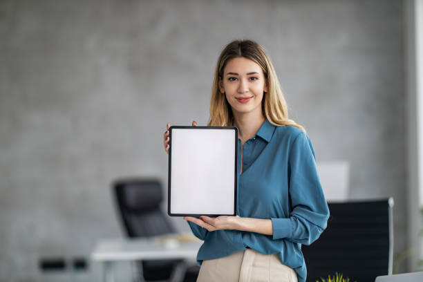 Woman holding digital tablet with blank white screen