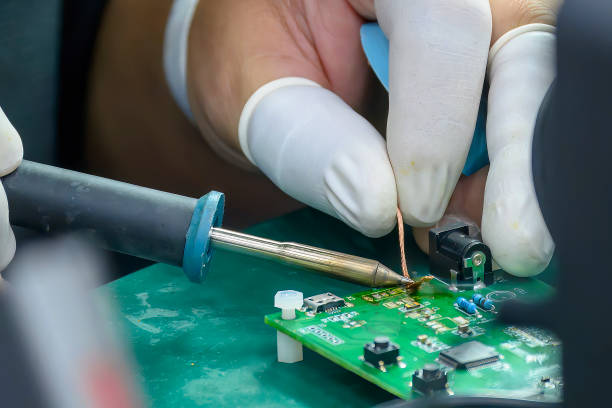 istock Close up scene the soldering operation by skill operator with rubber finger cot. 1565031697