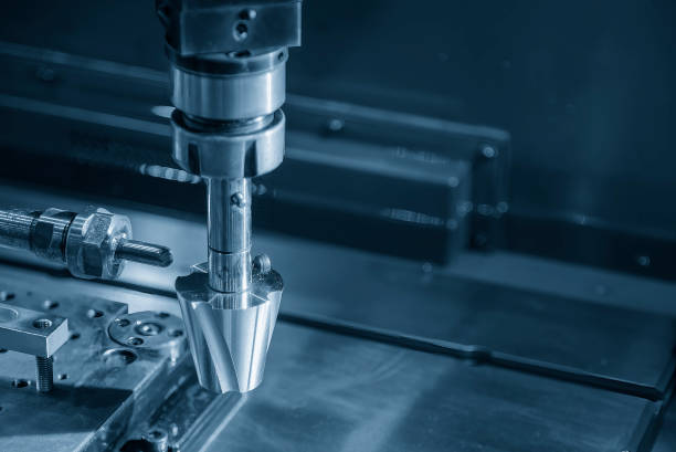 istock Close up scene the 4-axis EDM machine working process with copper electrode in the light blue scene. 1565032049