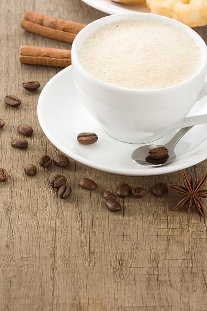 istock cup of coffee and beans on wood 156503427