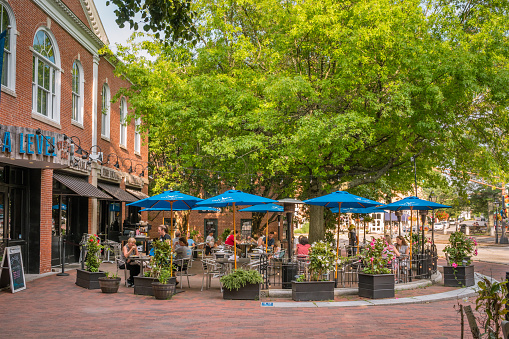 ewburyport, MA, US - July 13, 2023: Street scene in downtown of this small town with its quaint streets with 19th century brick buildings and trendy shops and restaurants.