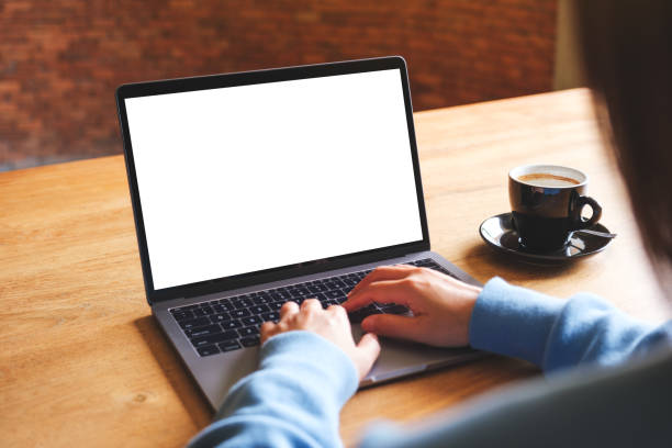 istock Mockup image of a woman using and typing on laptop computer with blank white desktop screen 1565044104