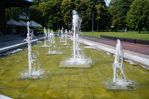 Horyniec-Zdroj, Subcarpathian: A child taking a refreshing dip in the fountain in the Spa Park on a hot summer day