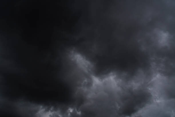 istock Dramatic dark storm rain clouds black sky background. Dark thunderstorm clouds rainny atmosphere. Meteorology danger windstorm disasters climate. Dark cloudscape storm disaster gloomy gray cloud sky 1565069009