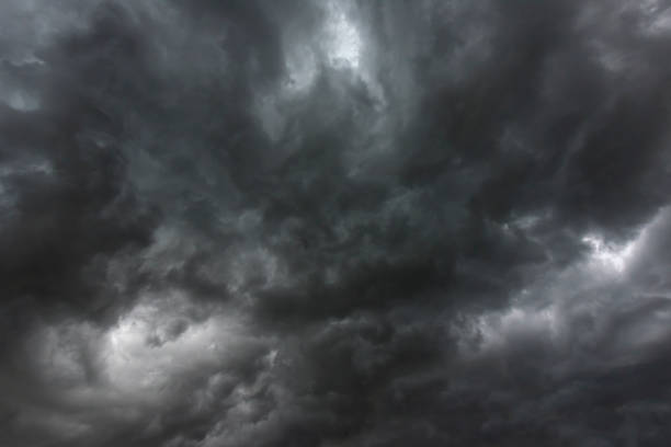 istock Dramatic dark storm rain clouds black sky background. Dark thunderstorm clouds rainny atmosphere. Meteorology danger windstorm disasters climate. Dark cloudscape storm disaster gloomy gray cloud sky 1565069611