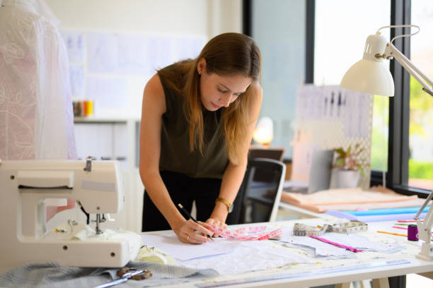 istock Beautiful woman dressmaker working in workshop studio 1565084781