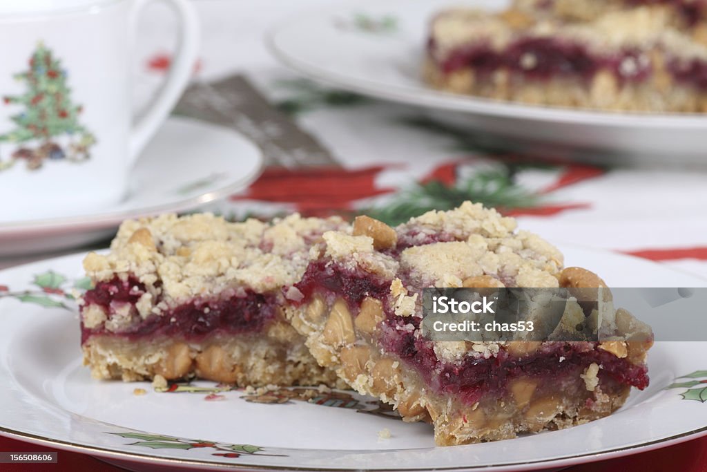 Cranberry Bar Dessert Two cranberry bars with peanut butter chips on a Christmas plate Chewy Stock Photo