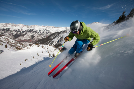 Skier on steep mountain slope