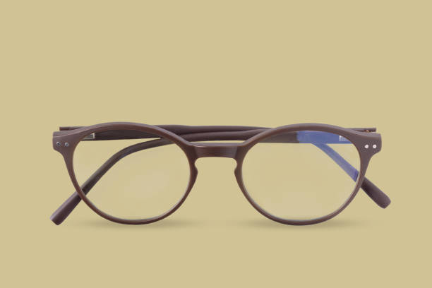 istock glasses on a yellow background, close-up 1565090711