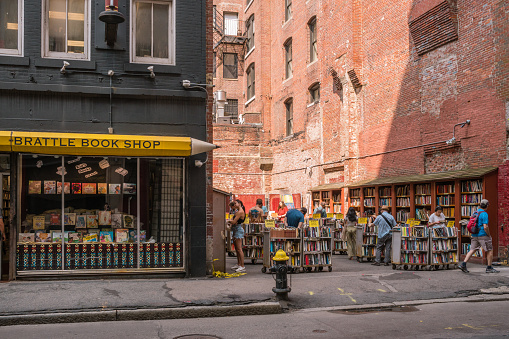 Boston, MA, US - July 10, 2023: Iconic local book store selling used books in downtown retail district. The stored opened in 1825 and sells books in an used parking lot next to the shop.