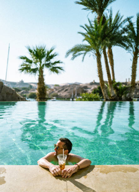 Tanning beds beside swimming pool in luxury hotel