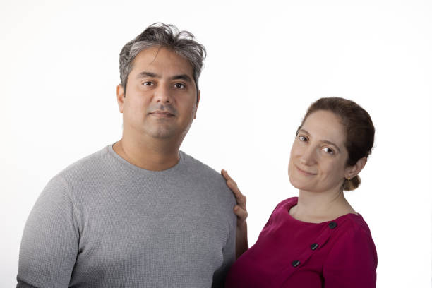 istock 40 year old Indian man with Tardive Dyskinesia looking at camera, caretaker providing support 1565130992