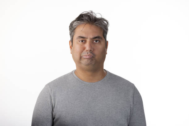 istock 40 year old Indian man with Tardive Dyskinesia looking at camera 1565130996