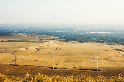 Tri-Cities Washington viewed elevated vantage point with wind turbines in foreground