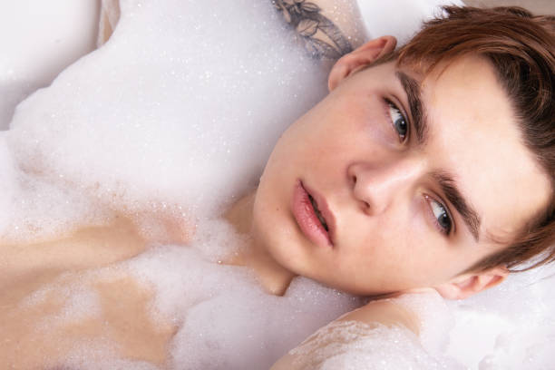 istock Relax and rest. Young attractive guy in the bath. 1565141161