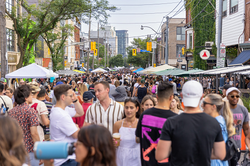 Toronto, Canada - July 22, 2023 : Crowds outside enjoying the annual street festival OssFest - Meet Me on Ossington