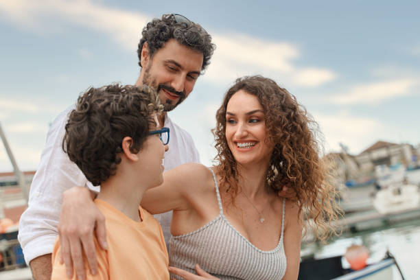 istock Young Married Couple and Son on a Docked Boat 1565177222